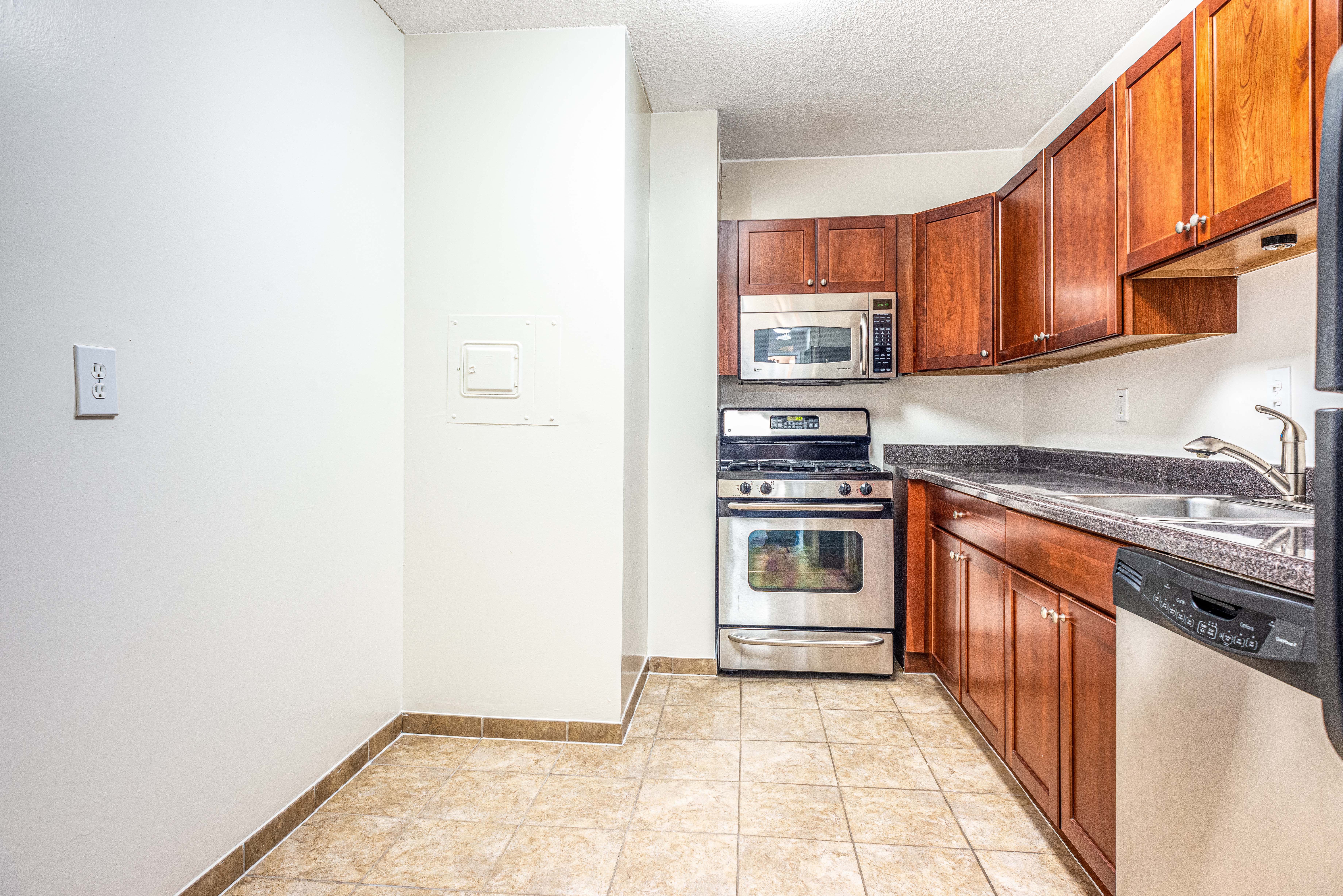 Updated kitchens with stainless steel appliances, cherry maple cabinets and gas range